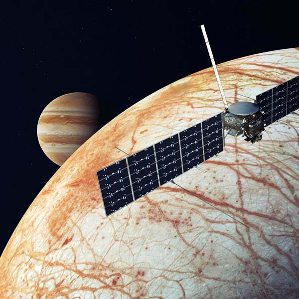 Spacecraft flying over Europa, one of Jupiter's moons.