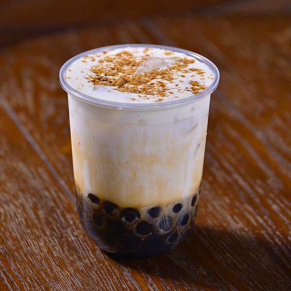 Bubble tea sitting on a wooden surface.